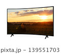 Curved screen tv from angled view with rural landscape with straw roll and sunset sky on screen 139551703