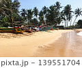 Fishing boats on a sandy beach 139551704
