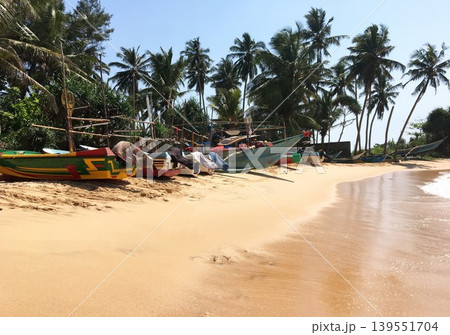 Fishing boats on a sandy beach 139551704