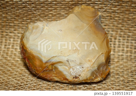 Roughly processed Late Bronze Age flint tool on burlap Roughly processed Late Bronze Age flint tool on burlap 139551917