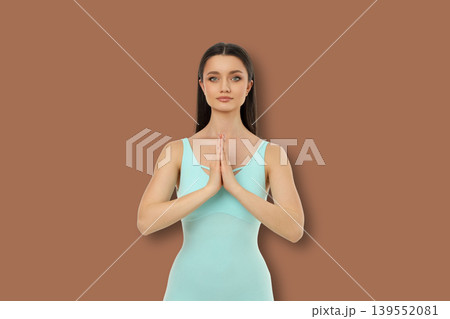 Yoga pose with hands together in front of the chest 139552081