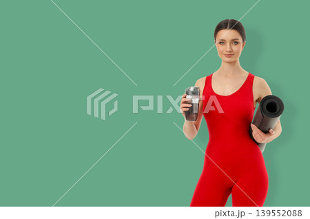 Yoga session with a person holding a mat and a drink Yoga session with a person holding a mat and a drink 139552088