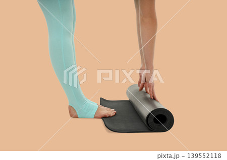 Yoga practice starts with rolling out a mat on floor 139552118