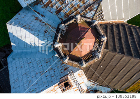Aerial view of the roof of an old manor house with a turret and spire 139552199