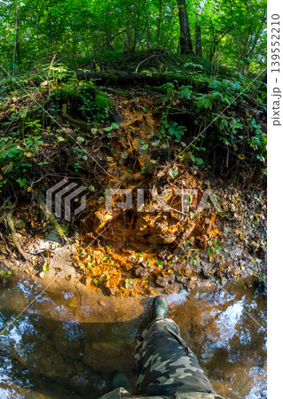 First person view of a brightly colored spring with ferruginous water 139552210