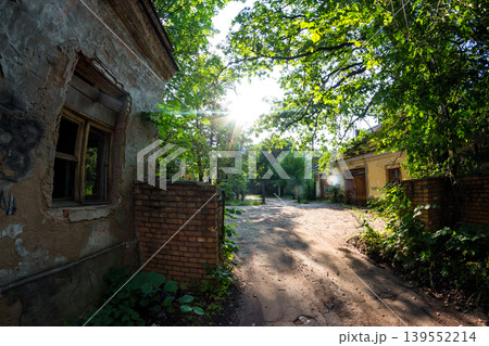 Abandoned checkpoint with a brick security booth surrounded by green thickets 139552214
