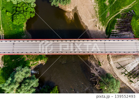 Top view of an asphalt road bridge and a small river Top view of an asphalt road bridge and a small river 139552493