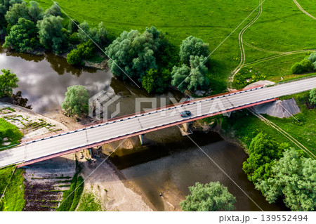 View from a drone of a road bridge over the river with cars driving along it 139552494