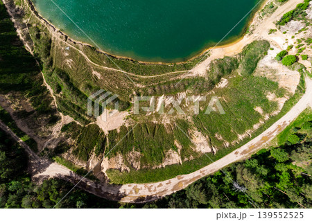 Top view of a steep slope of a flooded sand quarry 139552525