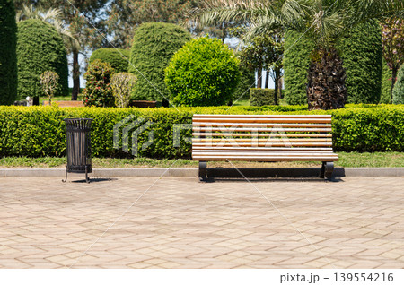 An empty wooden bench in a city park. 139554216