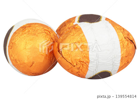Chocolate balls wrapped in foil isolated on white background Chocolate balls wrapped in foil isolated on white background 139554814