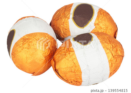 Chocolate balls wrapped in foil isolated on white background Chocolate balls wrapped in foil isolated on white background 139554815