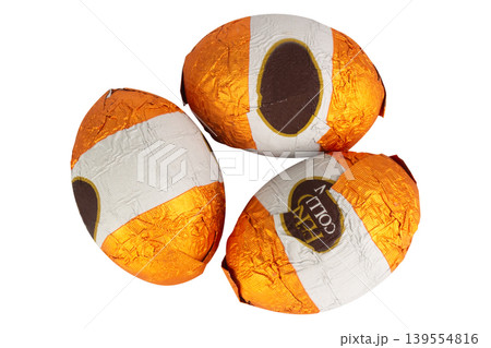 Chocolate balls wrapped in foil isolated on white background Chocolate balls wrapped in foil isolated on white background 139554816