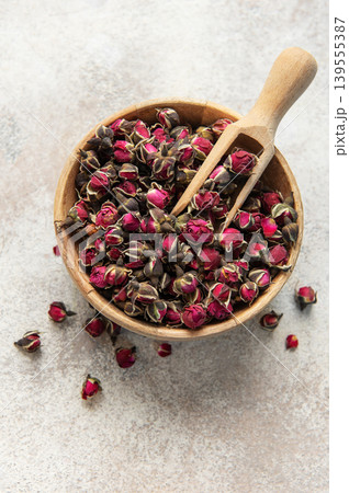 Dried rose buds in wooden bowl with scoop Dried rose buds in wooden bowl with scoop 139555387