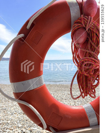 red lifebuoy conversation on a lifeguard tower by the sea red lifebuoy conversation on a lifeguard tower by the sea 139555629