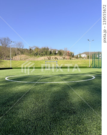 Outdoor artificial turf soccer field on a bright, sunny day 139555672