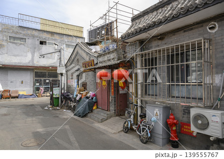 Narrow street with old houses and motorbikes in the Hutong district in Beijing 139555767