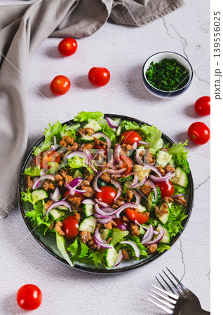 Fresh burger salad with ground beef and vegetables on a plate on the table vertical view Fresh burger salad with ground beef and vegetables on a plate on the table vertical view 139556025