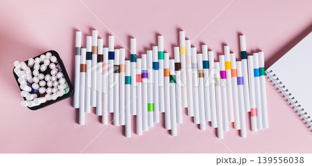 A set of acrylic markers for drawing and a sketchbook on a table top view web banner 139556038