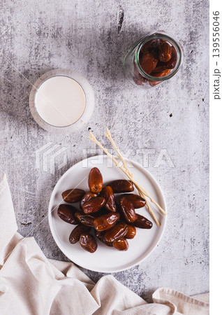 Healthy fresh dates in a bowl and milk in a glass on the table top and vertical view 139556046