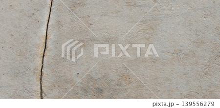 Grey concrete surface texture with aesthetic natural cracks. Grey concrete surface texture with aesthetic natural cracks. 139556279