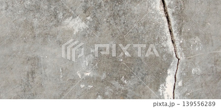 Grey concrete surface texture with aesthetic natural cracks. Grey concrete surface texture with aesthetic natural cracks. 139556289