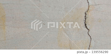 Grey concrete surface texture with aesthetic natural cracks. Grey concrete surface texture with aesthetic natural cracks. 139556290