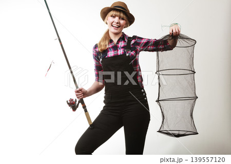 Happy woman holding fishing rod and keepnet 139557120