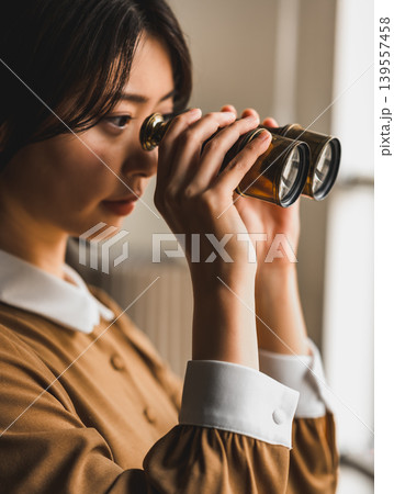 双眼鏡で遠くを見る女性 双眼鏡で遠くを見る女性 139557458