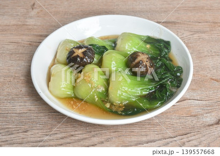 stir fried Chinese cabbage or Bok Choy topping black mushroom in gravy soy sauce on plate 139557668