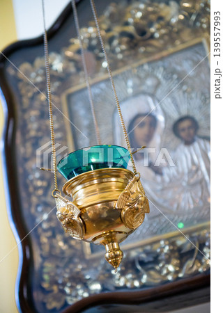 Hanging church lamp with green glass and icon background 139557993