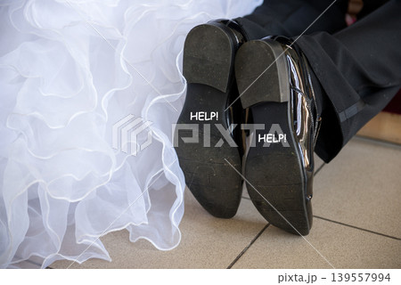 Wedding couple shoes with humorous help message Wedding couple shoes with humorous help message 139557994