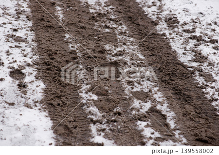 Fresh Tire Tracks Cutting Through Snow And Mud Fresh Tire Tracks Cutting Through Snow And Mud 139558002