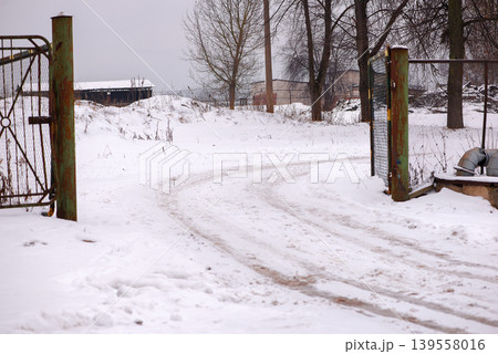 Industrial fence with small wooden structure in snow 139558016