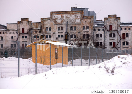 Large abandoned factory facade in winter landscape Large abandoned factory facade in winter landscape 139558017