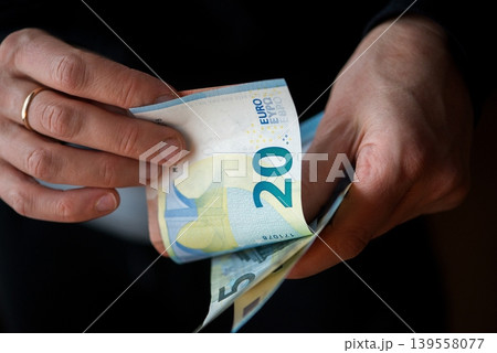 Counting Euro Banknotes In Hands 139558077