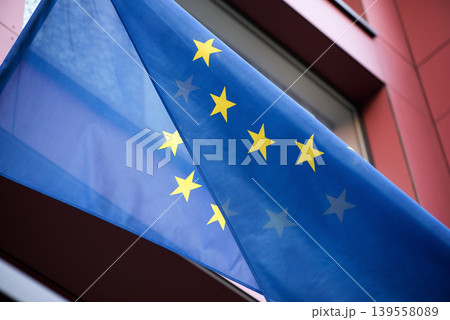 European Union Flag Against Modern Urban Facade European Union Flag Against Modern Urban Facade 139558089