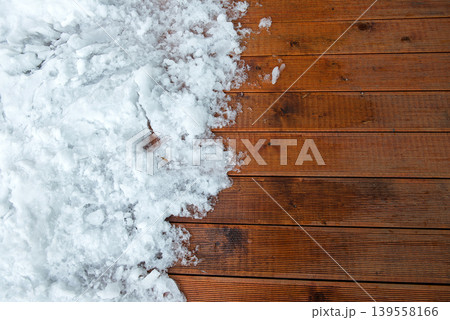 Contrast Between Fresh Snow And Warm Wooden Deck Surface 139558166