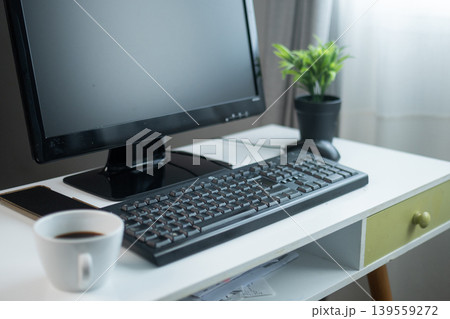 Modern home office desk with computer and coffee cup 139559272