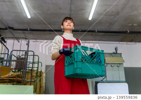 女性がコンテナを運ぶ 女性がコンテナを運ぶ 139559836