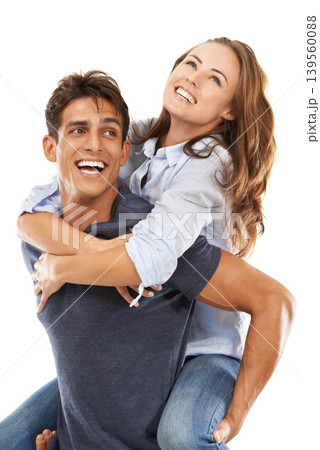 Happy couple, hug and piggyback for care, love or compassion on a white studio background. Handsome man and young woman smile enjoying back ride for romance, affection or fun relationship together 139560088