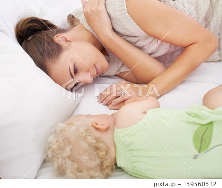 Bonding, sleeping and mom with baby on bed for dreaming, relax and happy cute family time. Love, smile and young mother watching girl child, kid or toddler taking a nap in bedroom or nursery at home Bonding, sleeping and mom with baby on bed for dreaming, relax and happy cute family time. Love, smile and young mother watching girl child, kid or toddler taking a nap in bedroom or nursery at home 139560312