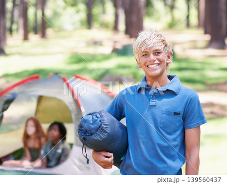 Sleeping bag, camping or portrait of kid in nature playing, adventure or holiday vacation in park. Relax, start or happy child with smile in woods, garden or forest reading for fun hiking or wellness 139560437