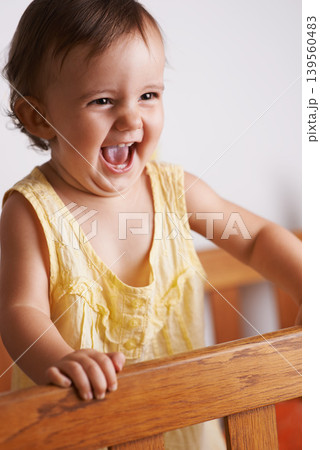 Cute, happy and a child in a crib for playing, wake up or comfort in a bedroom. Laughing, baby and a young kid in a nursery or room for thinking, idea or innocent standing for development in a home Cute, happy and a child in a crib for playing, wake up or comfort in a bedroom. Laughing, baby and a young kid in a nursery or room for thinking, idea or innocent standing for development in a home 139560483
