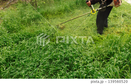 a man working in the green grass 139560520