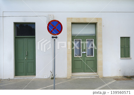 the no-stopping sign between two doors in a street in Larnaka, Cyprus the no-stopping sign between two doors in a street in Larnaka, Cyprus 139560571