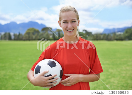Woman, field and portrait with soccer ball, happy and football pitch for match, competition or game. Fitness, practice and ready for training, outdoor and exercise for athlete, strong and sport Woman, field and portrait with soccer ball, happy and football pitch for match, competition or game. Fitness, practice and ready for training, outdoor and exercise for athlete, strong and sport 139560926
