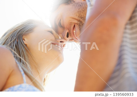 Forehead, eye contact or happy couple hug in outdoor on date for support or love in nature together. Low angle, romantic man or woman with smile on holiday vacation for fun bond, travel or wellness Forehead, eye contact or happy couple hug in outdoor on date for support or love in nature together. Low angle, romantic man or woman with smile on holiday vacation for fun bond, travel or wellness 139560933