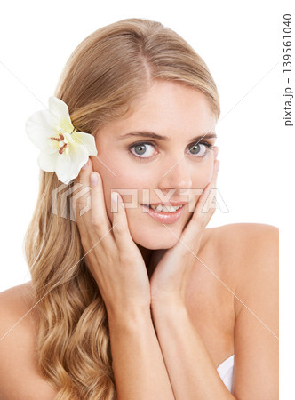 Woman, portrait and beauty in studio with flower, confidence and pride for cosmetic treatment or glow. Model, person or face with smile for haircare organic skincare, or self care on white background 139561040