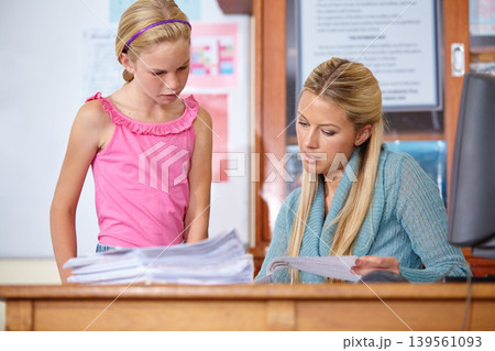 Woman, girl and mark paper in classroom, education and learning with portfolio, test or project. Teaching for development, exam and study, teacher explaining subject to student and test in class Woman, girl and mark paper in classroom, education and learning with portfolio, test or project. Teaching for development, exam and study, teacher explaining subject to student and test in class 139561093